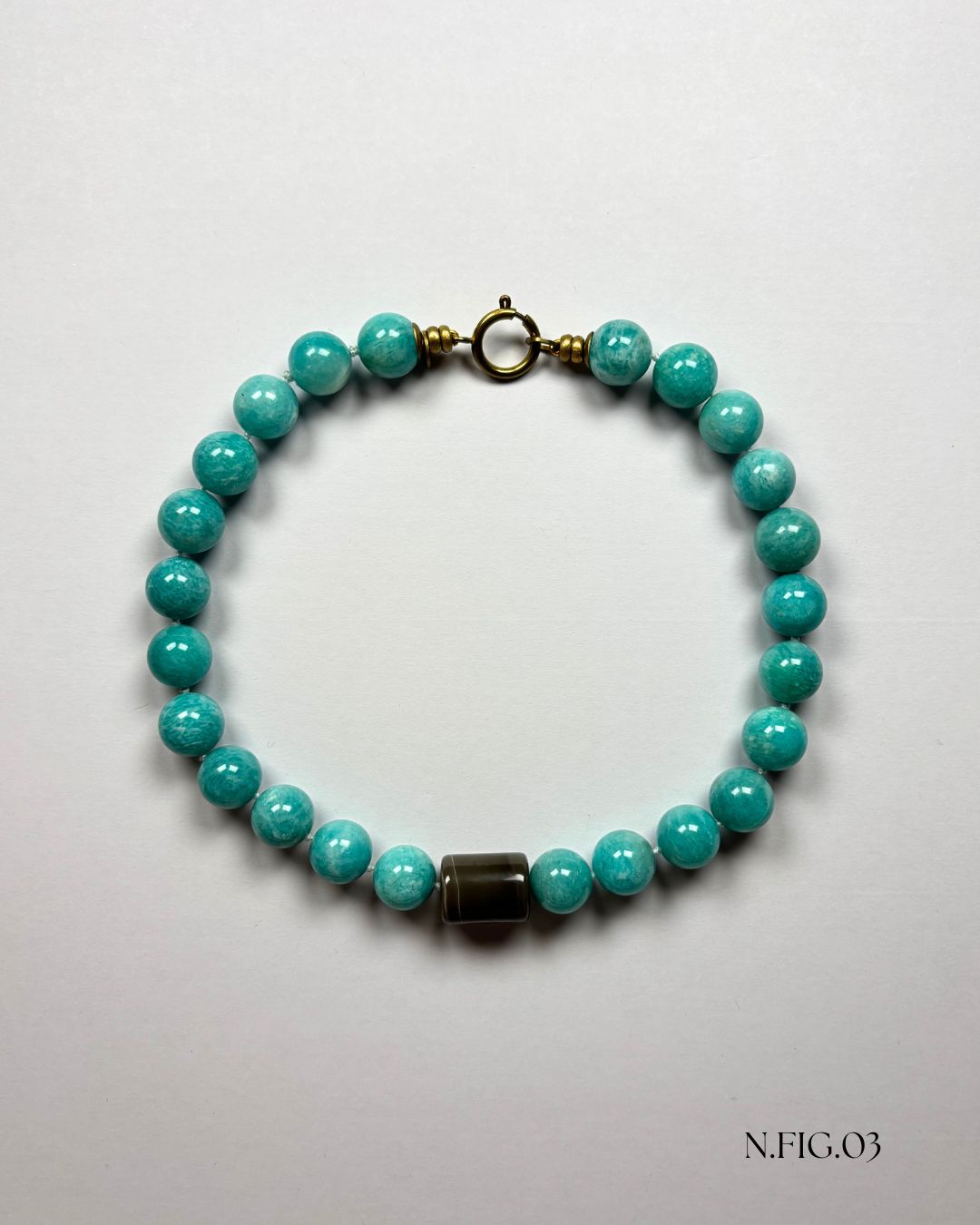 Delicate 16-inch necklace composed of amazonite turquoise and grey lace agate beads, woven on silk. The mix of aqua and grey stones suggests tranquility and balance.