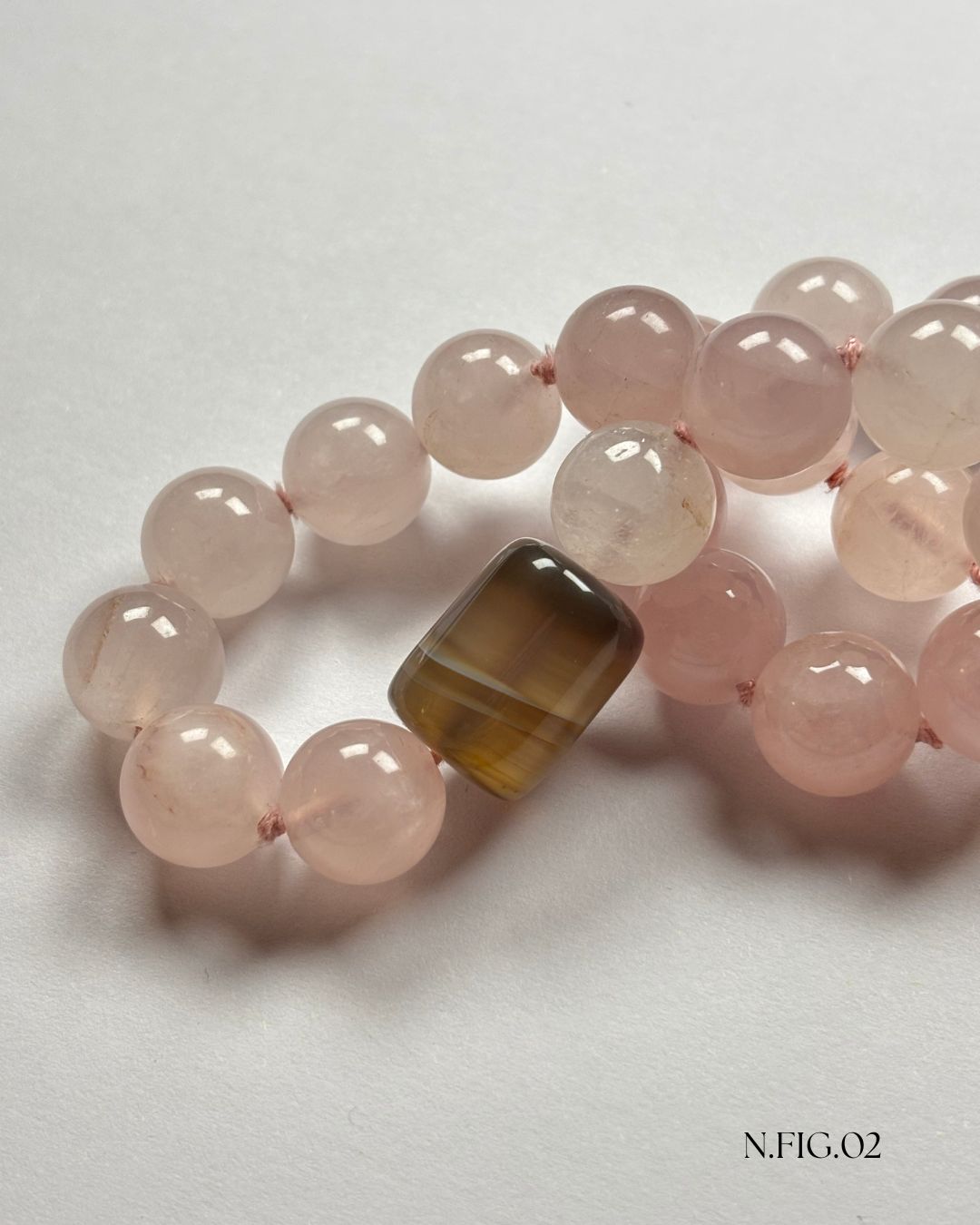 16-inch necklace featuring soft pink rose quartz and grey lace agate beads, elegantly strung on silk. The gentle hues evoke calm and emotional warmth.