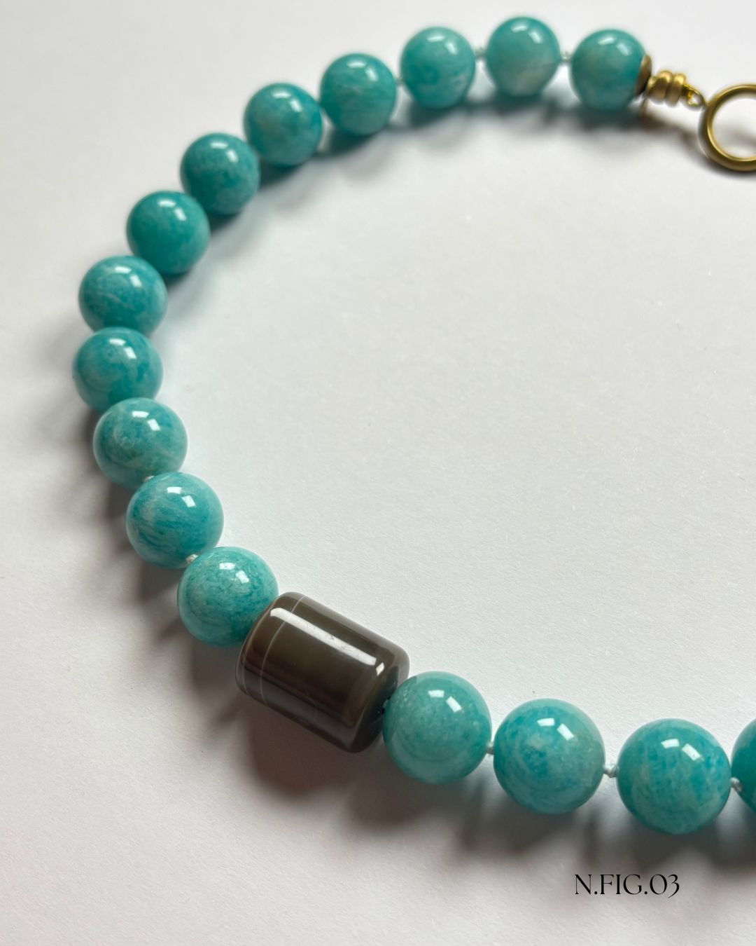 Delicate 16-inch necklace composed of amazonite turquoise and grey lace agate beads, woven on silk. The mix of aqua and grey stones suggests tranquility and balance.