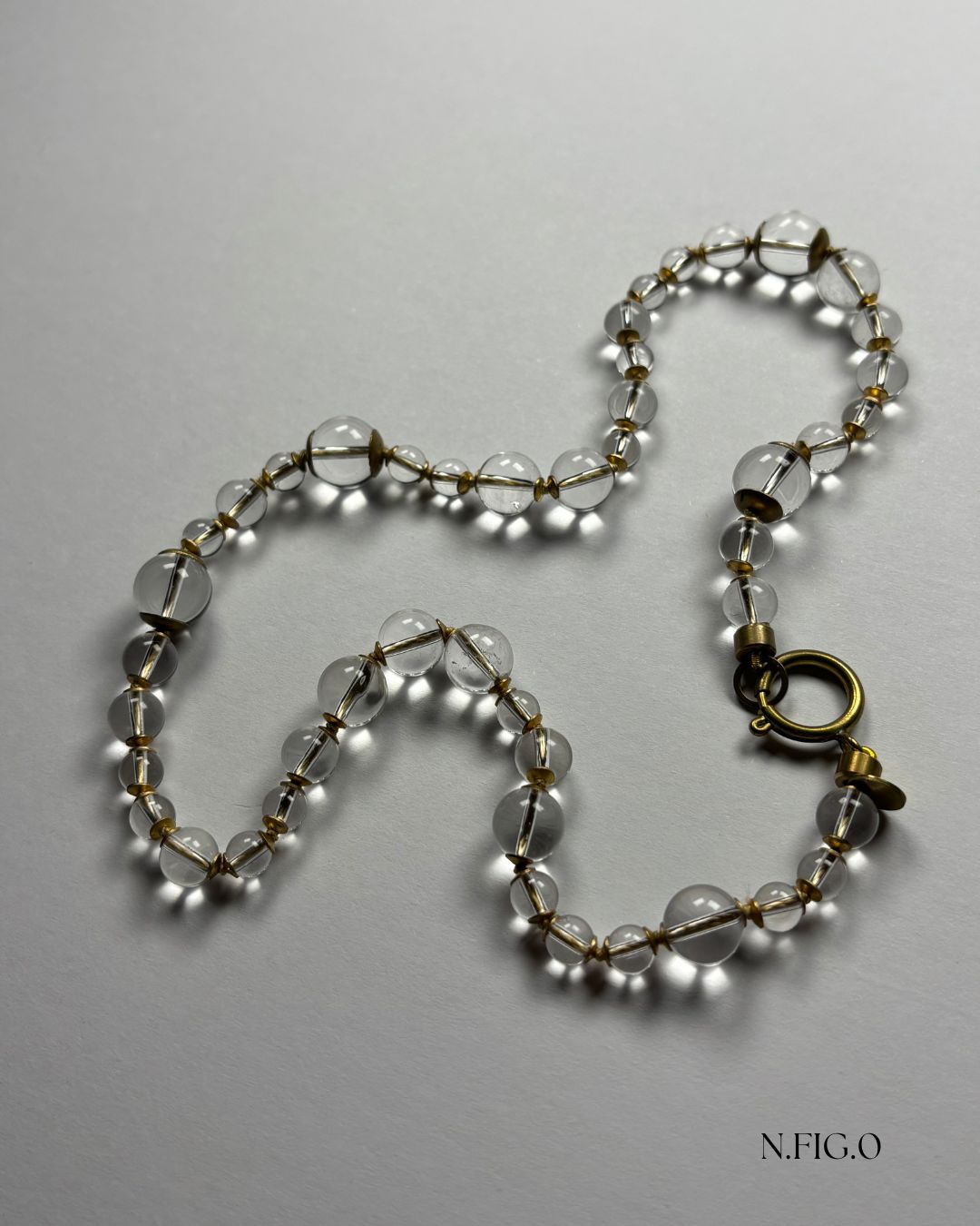 Minimalist clear stone necklace featuring rock crystal beads and handcrafted details